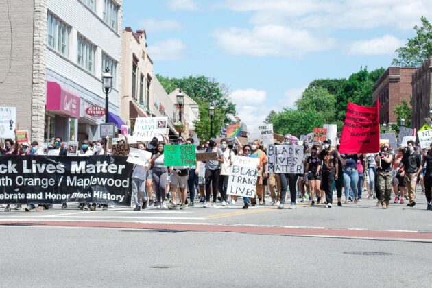participants marching with Black Lives Matter signs.
